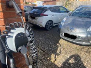 Two EV Nissan Leafs and one PodPoint charger near a residential property in the UK